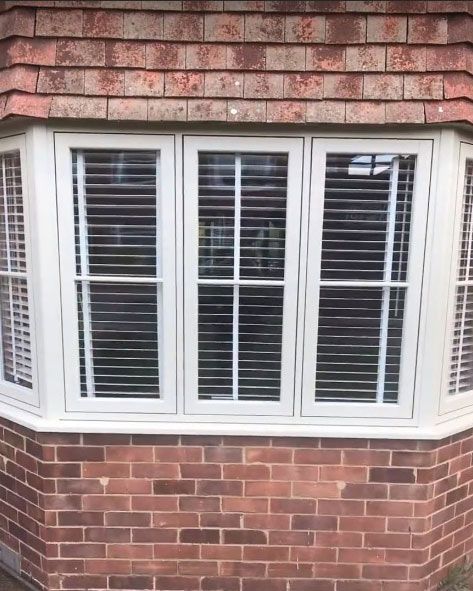 uPVC flush bay window with Georgian bars in a red brick front